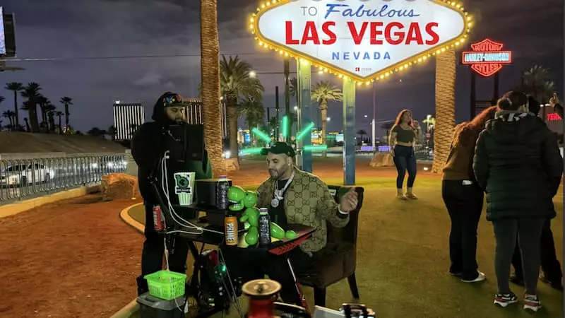 M2THAK streaming in front of the Las Vegas sign